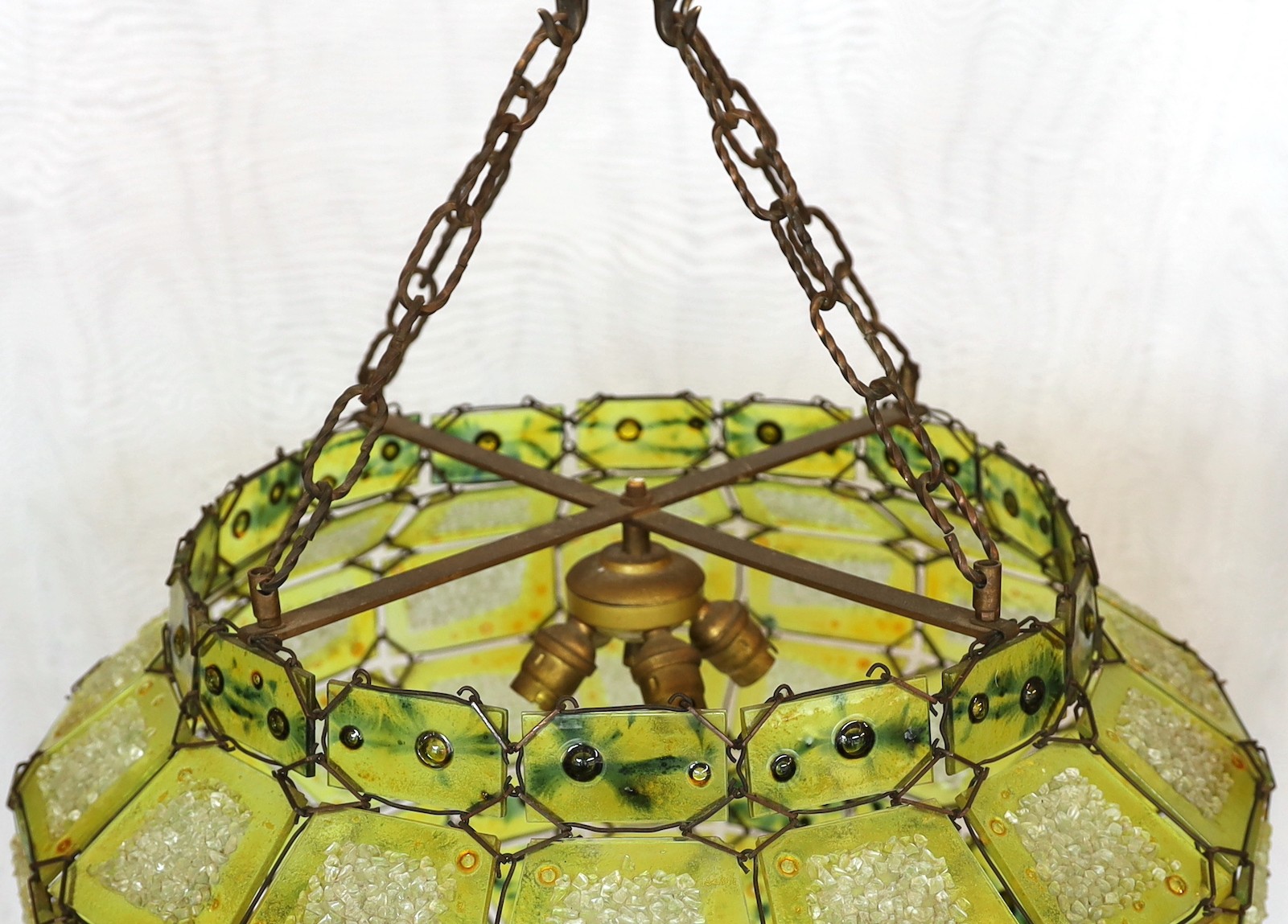 A 1930s Venetian panelled green glass light fitting with central light bulb holder, drop from rose 65cm. width 50 cm